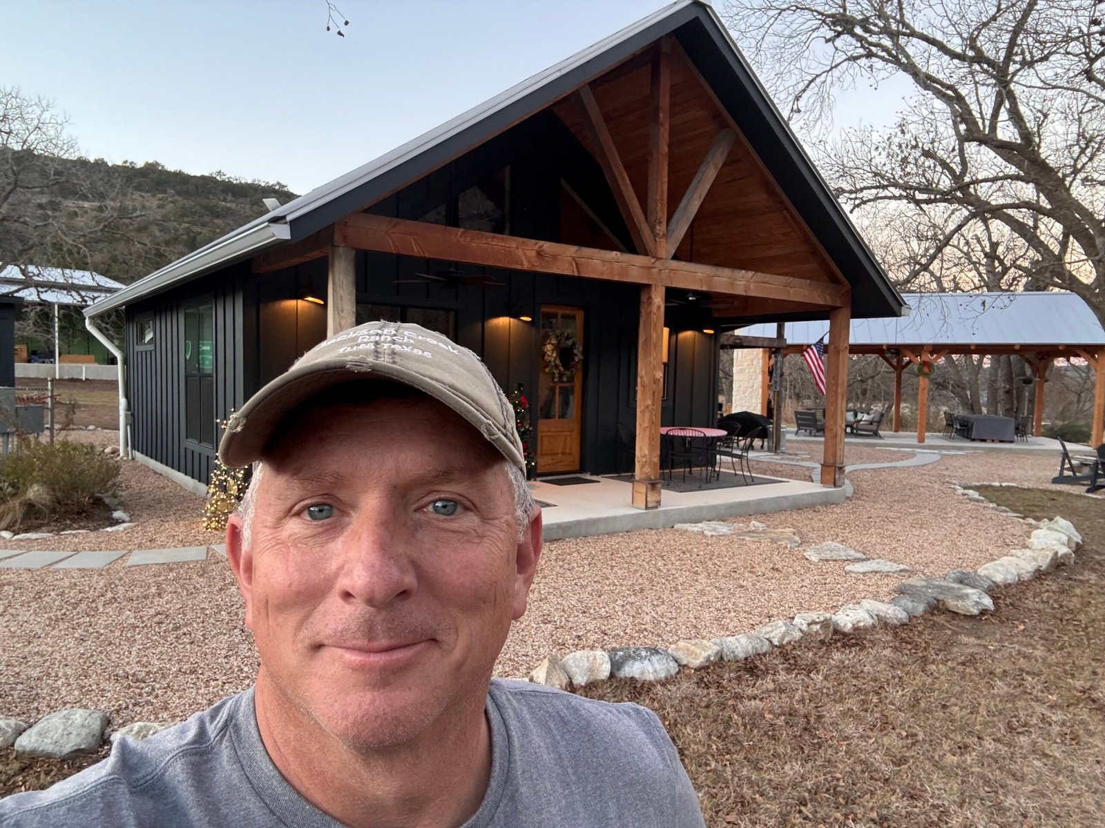 Photo of client standing in front of their custom home built by 919 Custom Homes