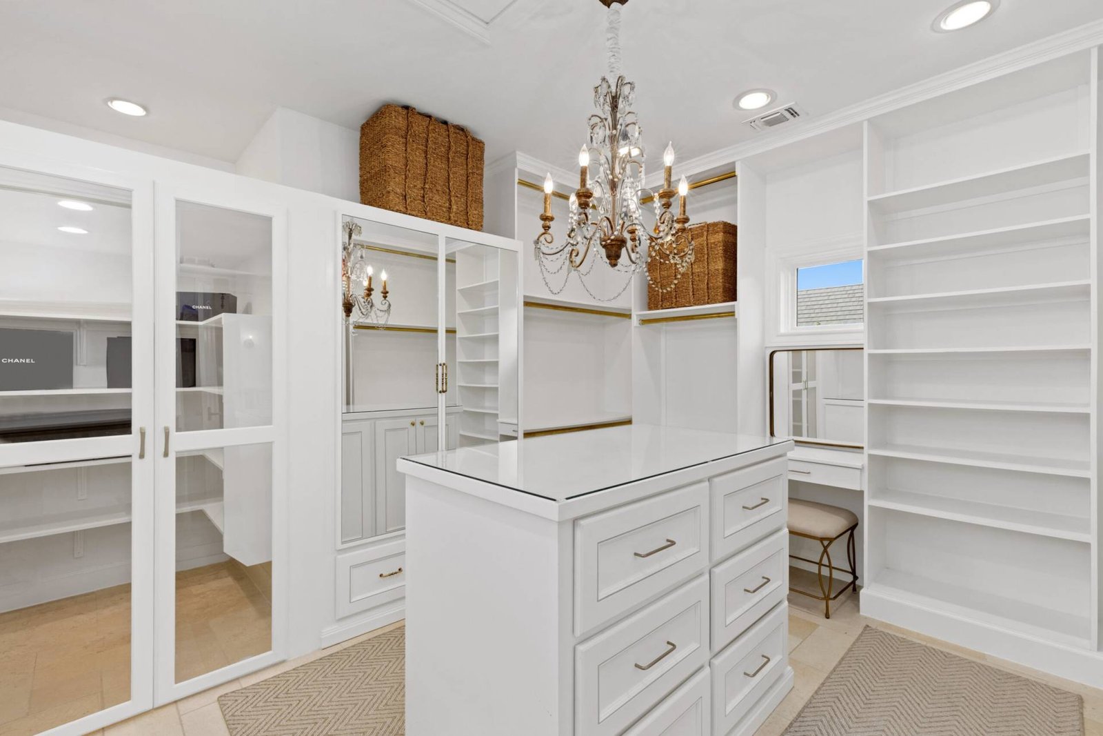 French Country custom home master closet with floor to ceiling built ins center island soft close drawers designer lighting and hardwood floors by luxury home builder 919 TX